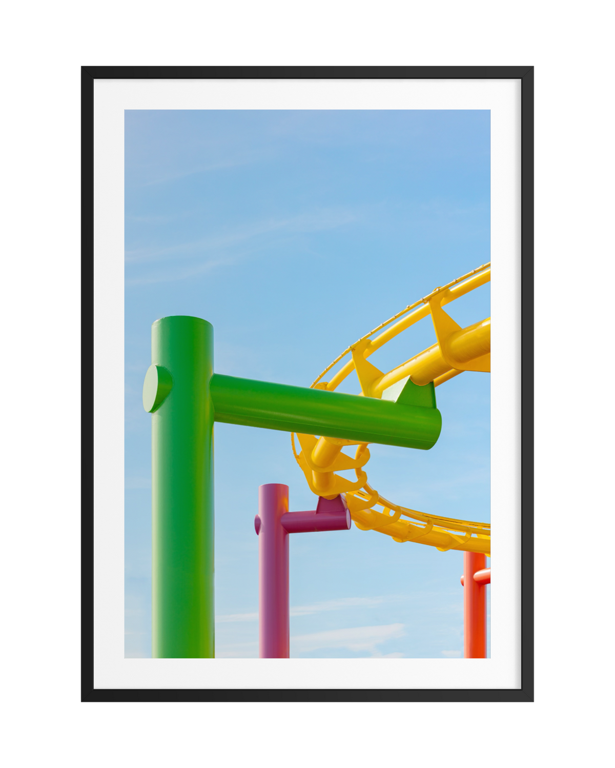 Bright roller coaster tracks stand out against a blue sky, bordered by a black frame in Coney Island, Brooklyn.