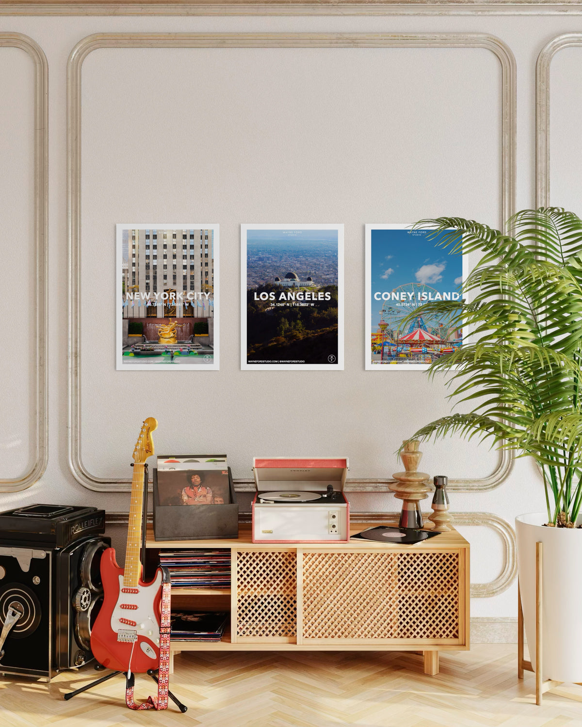 Room with guitar, record player, potted plants, and Coney Island city poster among three framed city prints.