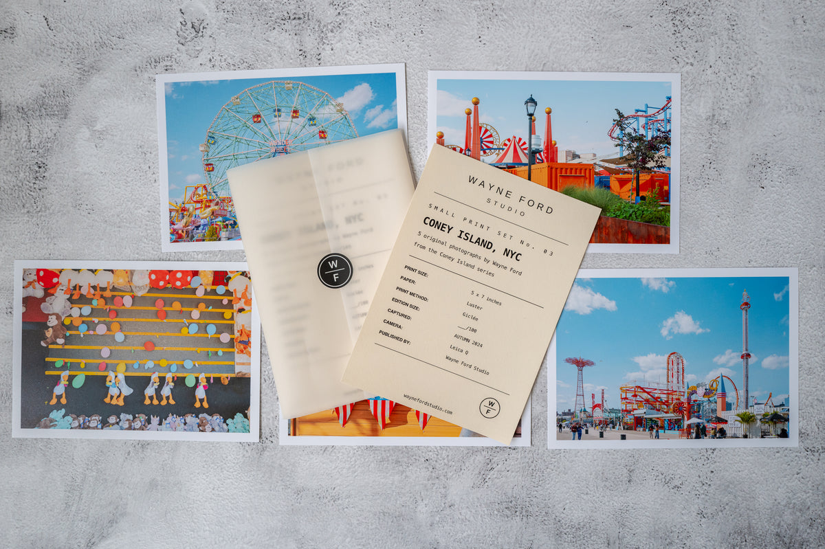 Color photo print of Coney Island, New York, featuring the boardwalk and amusement park rides.