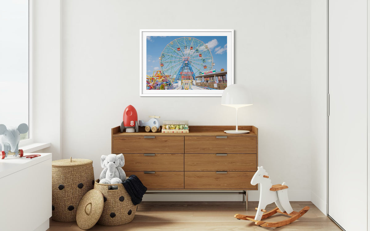 Coney Island Wonder Wheel photograph above a wooden dresser and toys in a children’s room.
