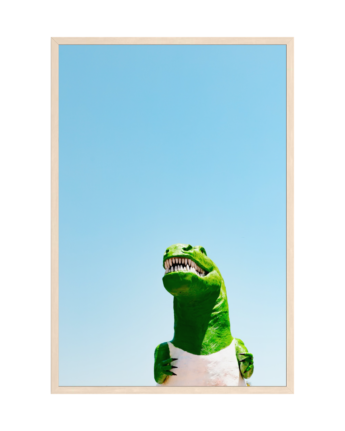 Giant Dino statue with white belly stands outdoors under the California sky in a light wood frame.