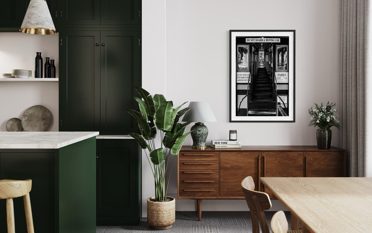 Modern dining room with green cabinets, wood sideboard, plant, and black-and-white DTLA Funicular Passage wall art.