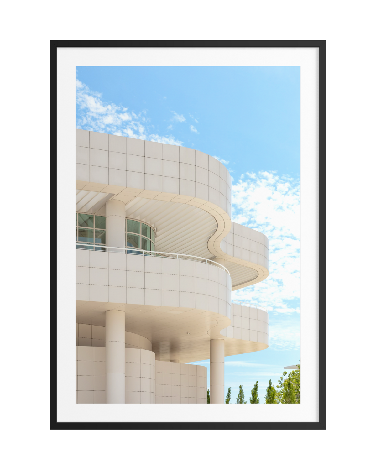 White modernist architecture with pillars at the Getty Center under a bright Los Angeles sky with scattered clouds.