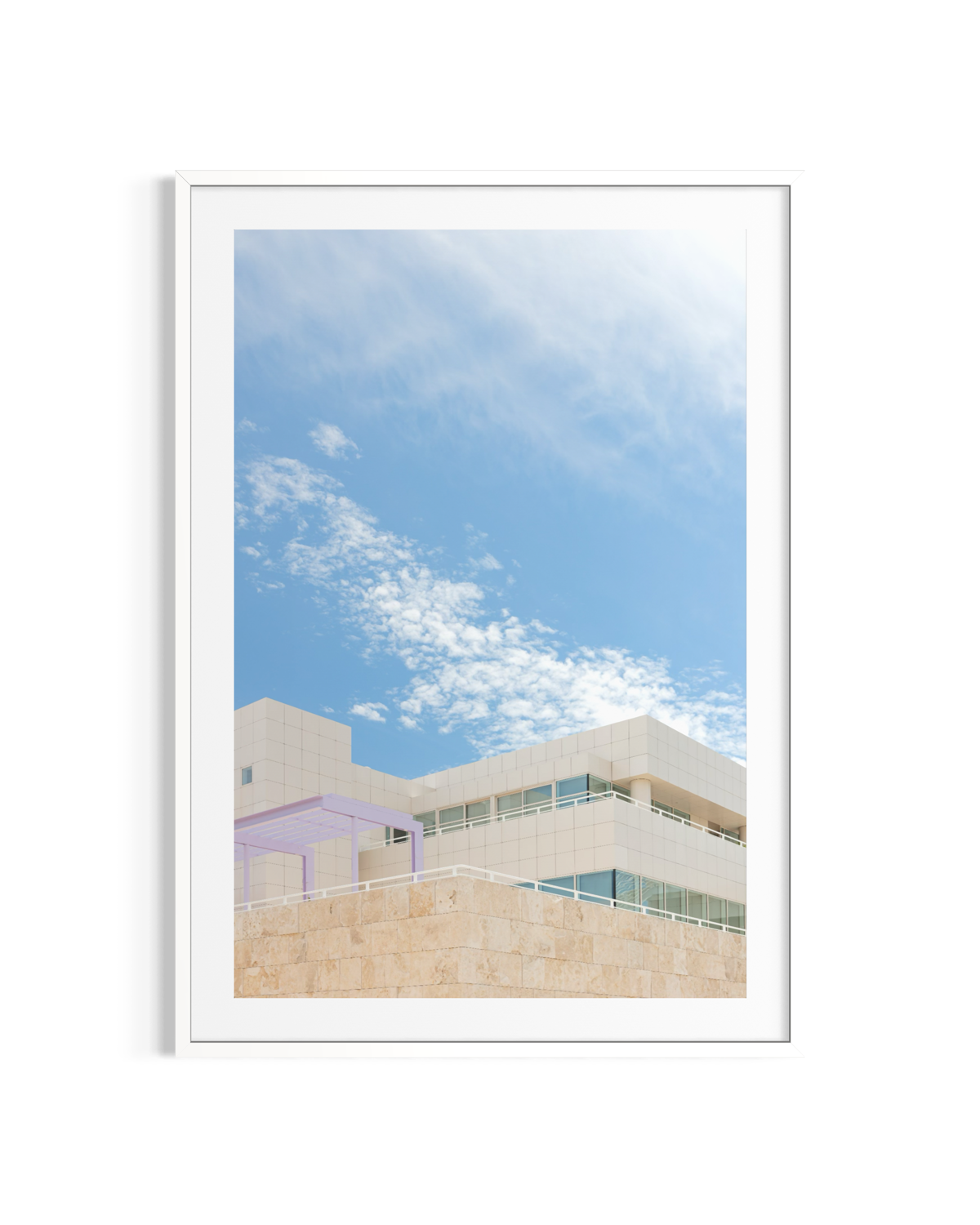 Getty Center’s modern travertine structure in Los Angeles under a blue sky, framed in white.