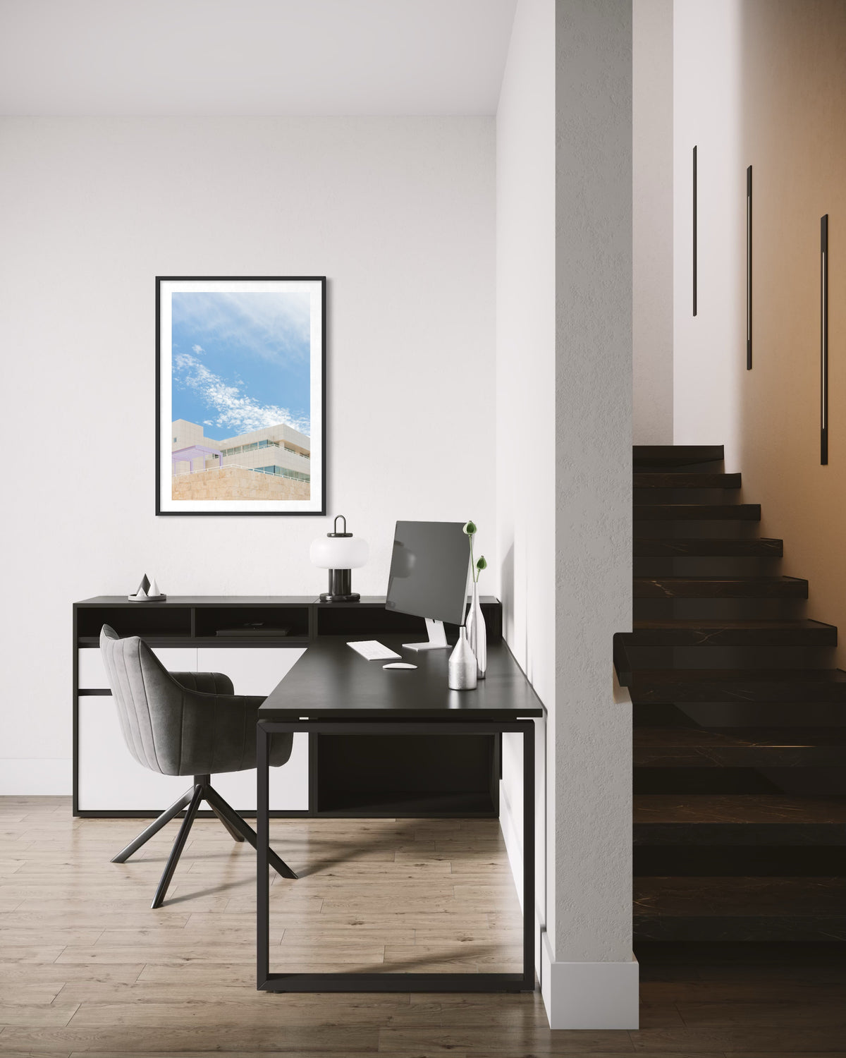 Black desk and gray chair in front of white Getty Center II building, Los Angeles.