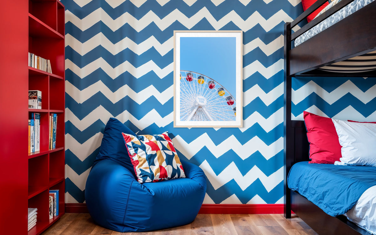 Blue zigzag walls, playful decor, bunk bed, red bookshelf, and “Going in Circles” photo in a children’s room.