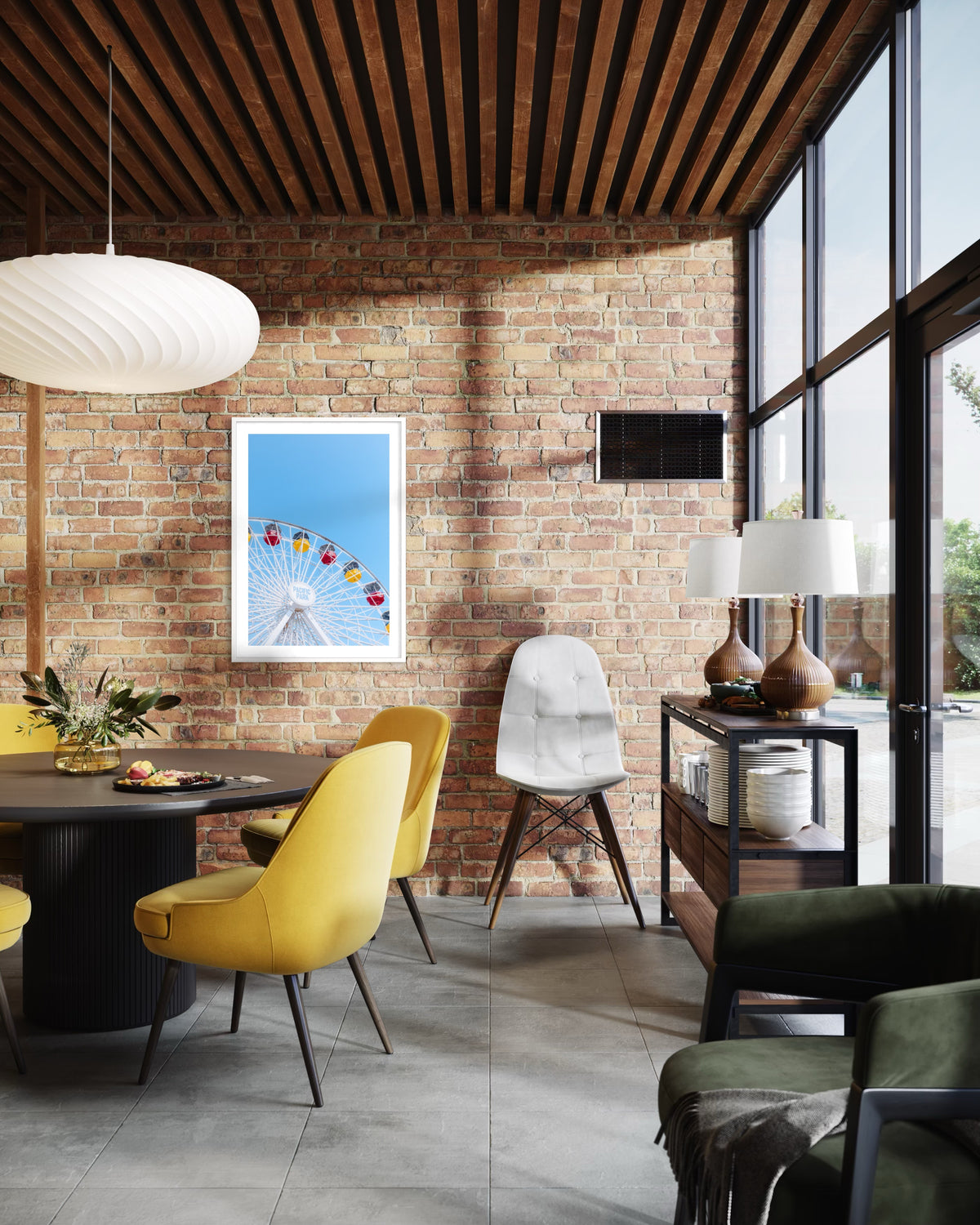 Yellow chairs and a brick wall under a pendant light in a Santa Monica dining area with circle-themed art.