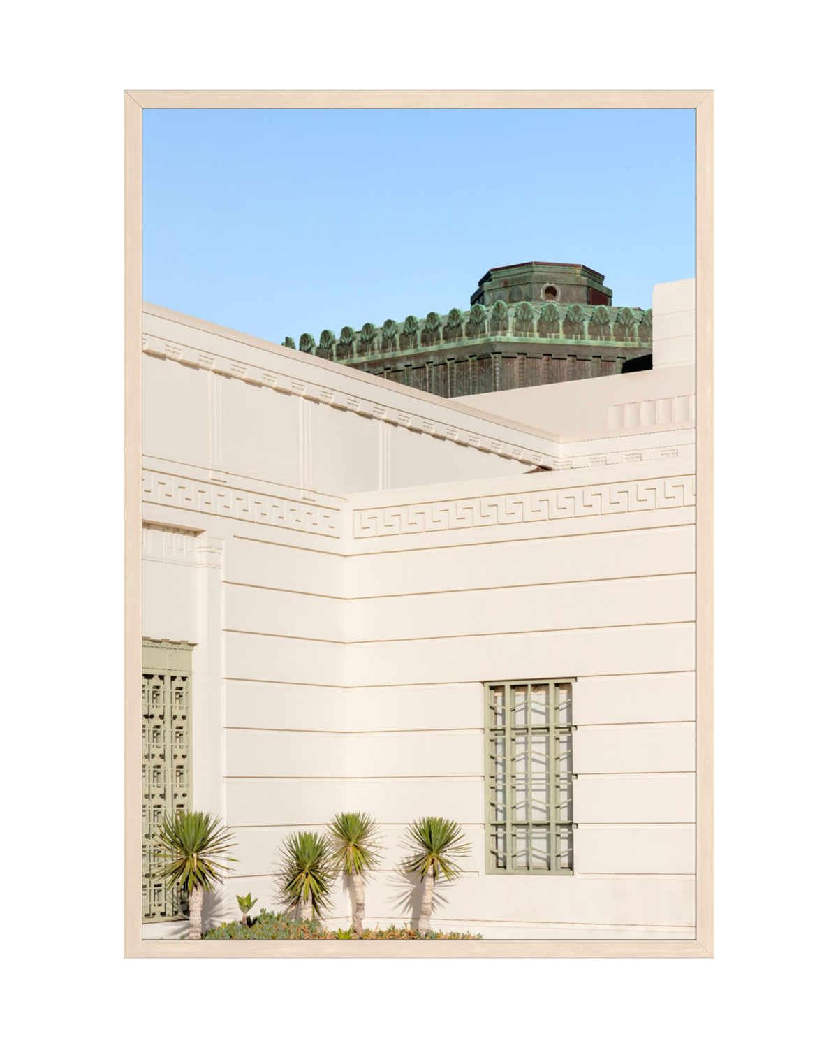 Griffith Observatory in Los Angeles with Art Deco details, palm plants, and a clear blue sky.