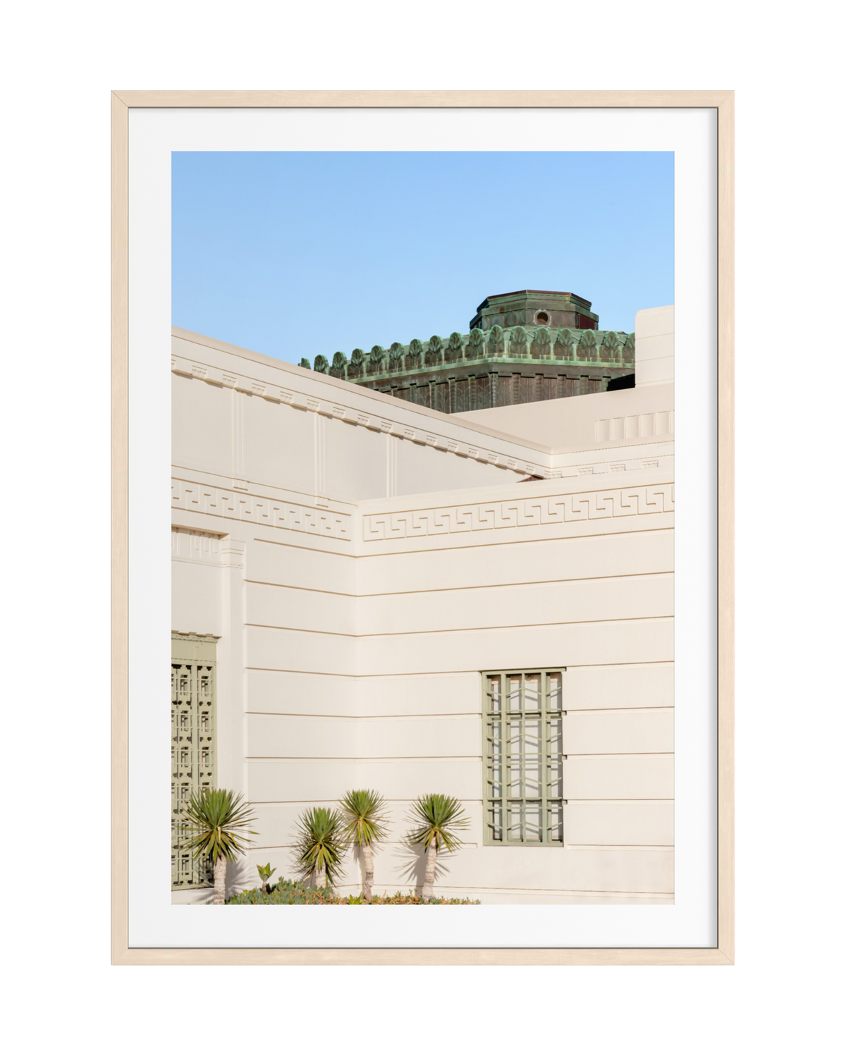 Griffith Observatory in Los Angeles with Art Deco details, metal windows, and five palm plants in front.