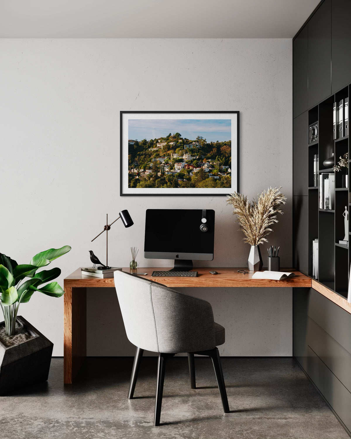 Wooden desk with computer and potted plant in a Hollywood Hills home office.