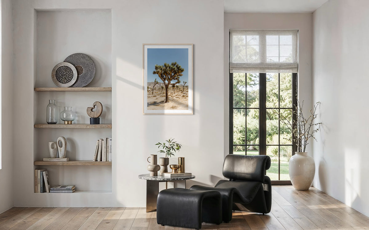 “Joshua Tree I” print displayed in a modern living room with a black chair, art, and built-in shelves.