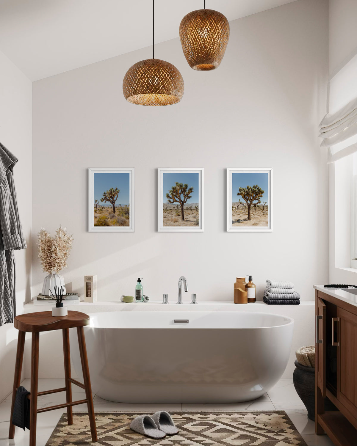 Modern bathroom with freestanding tub, wooden stool, and Joshua Tree landscape photograph above the tub.