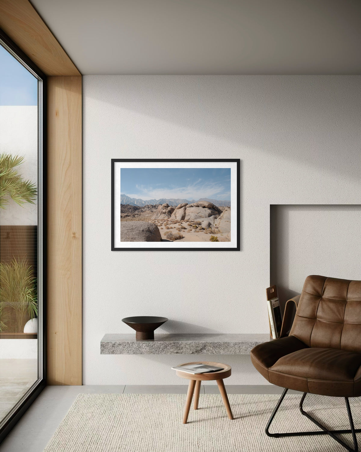 Leather chair in living room with Lone Pine, California mountain landscape art and Sierra Nevada views.