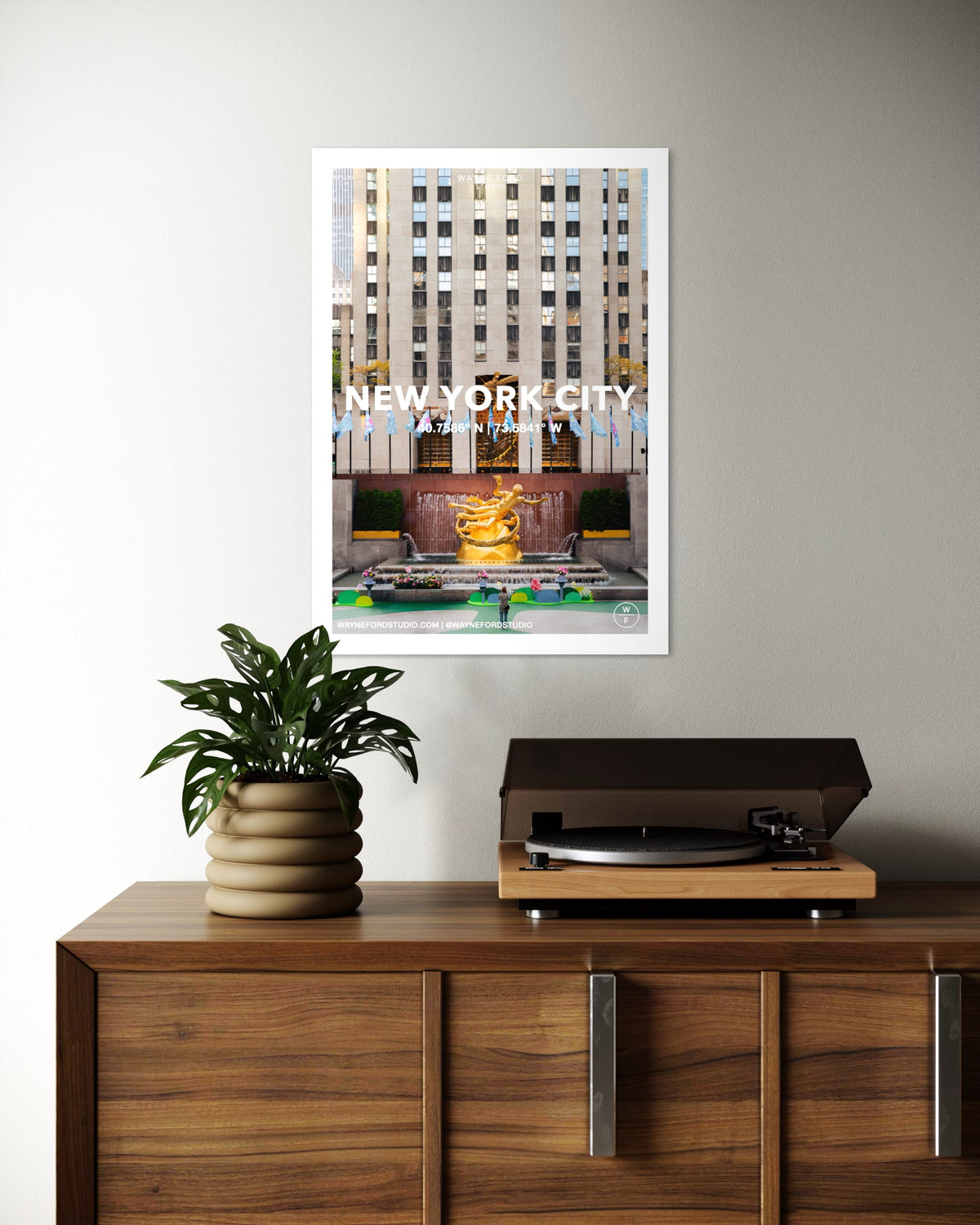 Los Angeles, New York City, and Coney Island posters hang above a cabinet with a plant and record player.