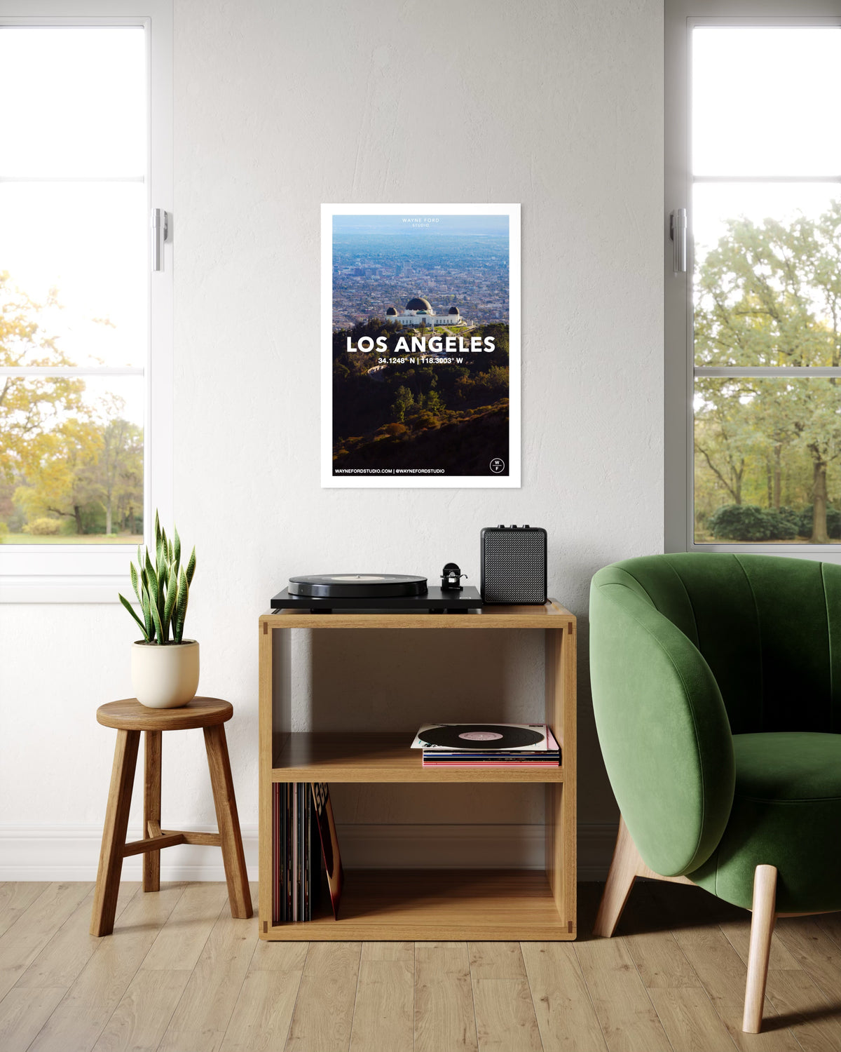 Los Angeles print displayed above a record shelf, near a green chair and leafy plant in a modern room.