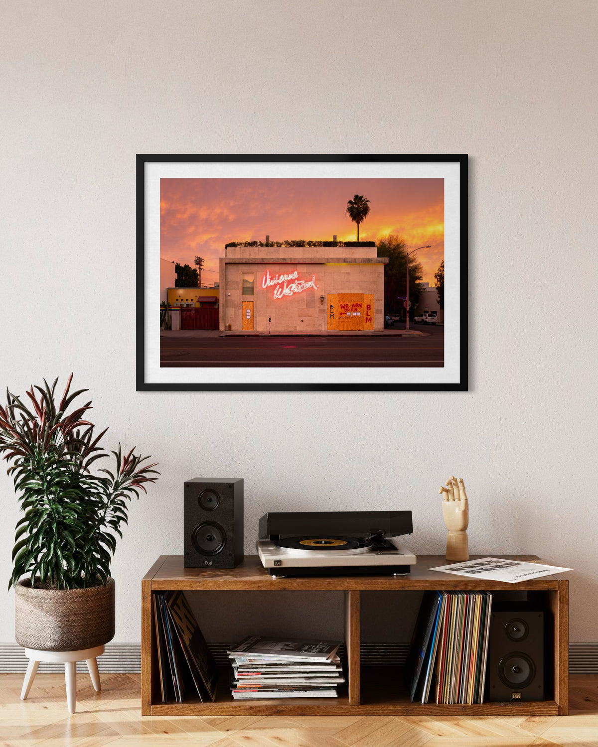 Framed “Melrose Avenue, the Summer of 2020” Los Angeles street photo above a record player, speakers, and plant.