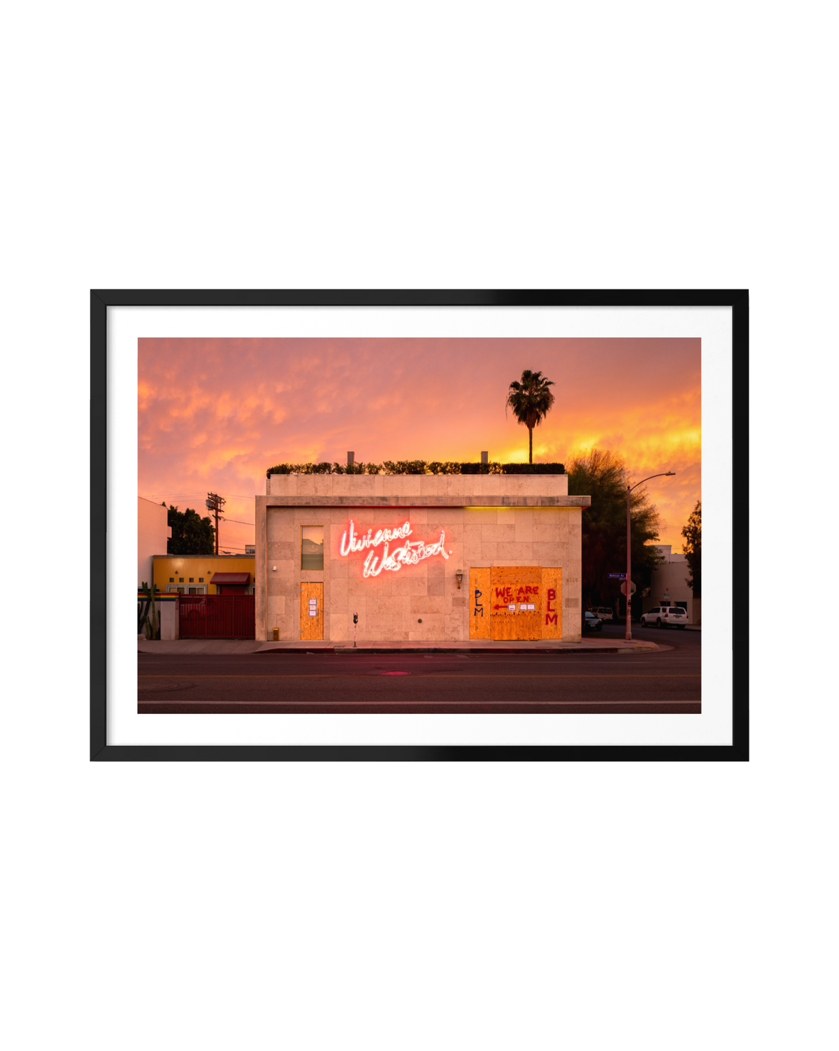 Framed print of a neon “Unicorns Welcome” sign glowing at sunset on Melrose Avenue, Los Angeles.