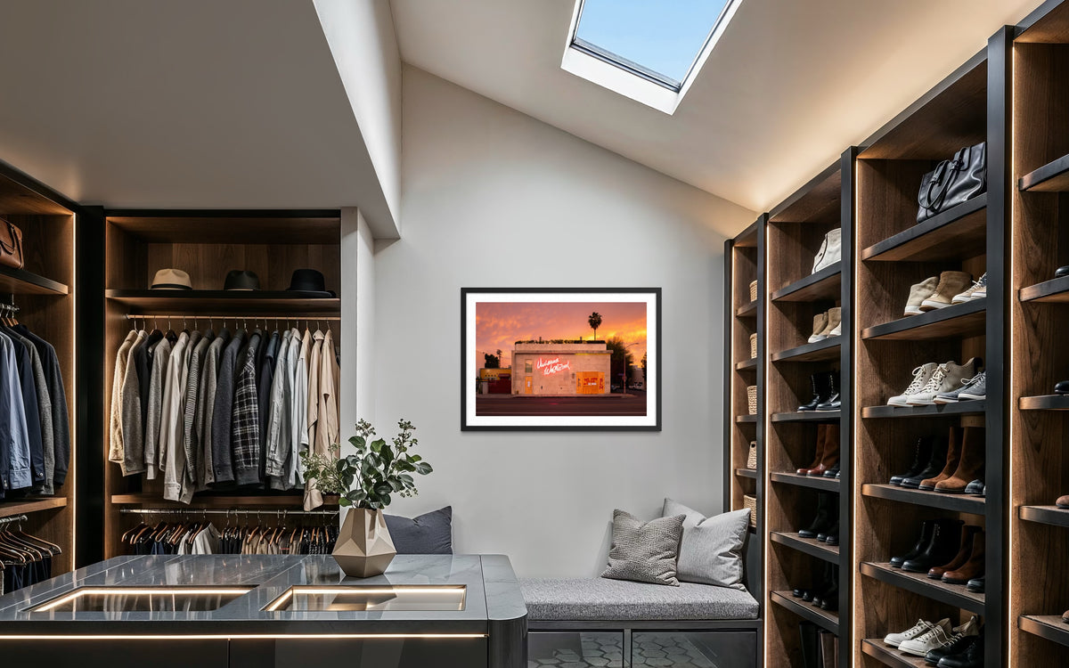 Walk-in closet with shelves, shoes, and skylight; “Melrose Avenue, the Summer of 2020” Los Angeles photo on wall.