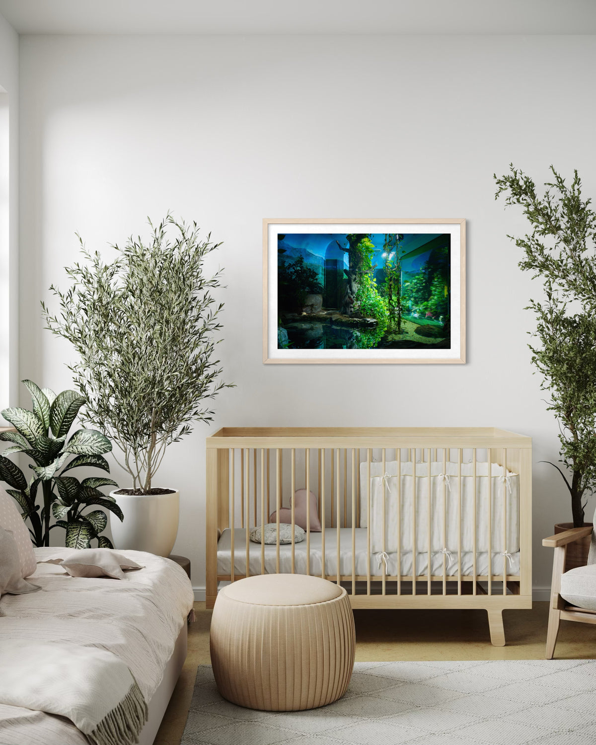 A nursery with a crib, potted plants, and a framed nature print on the wall.