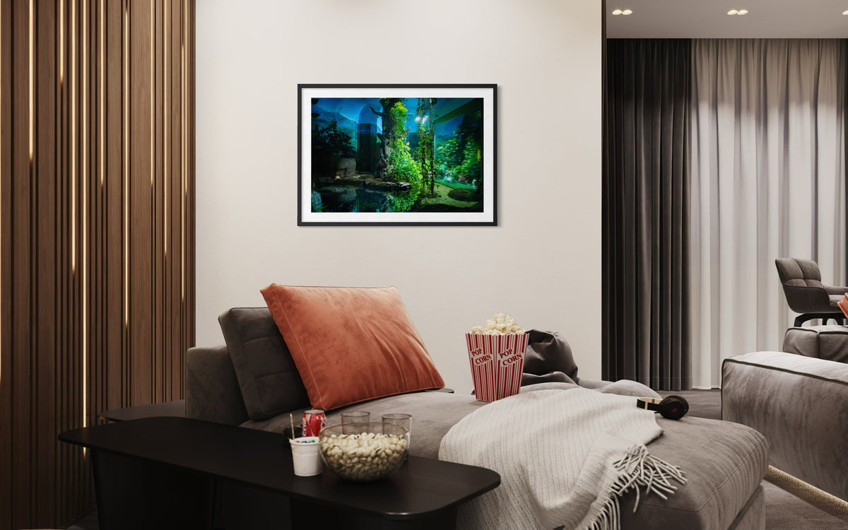 Gray chaise lounge with snacks and a blanket; “Night at the Zoo” photograph hangs above.
