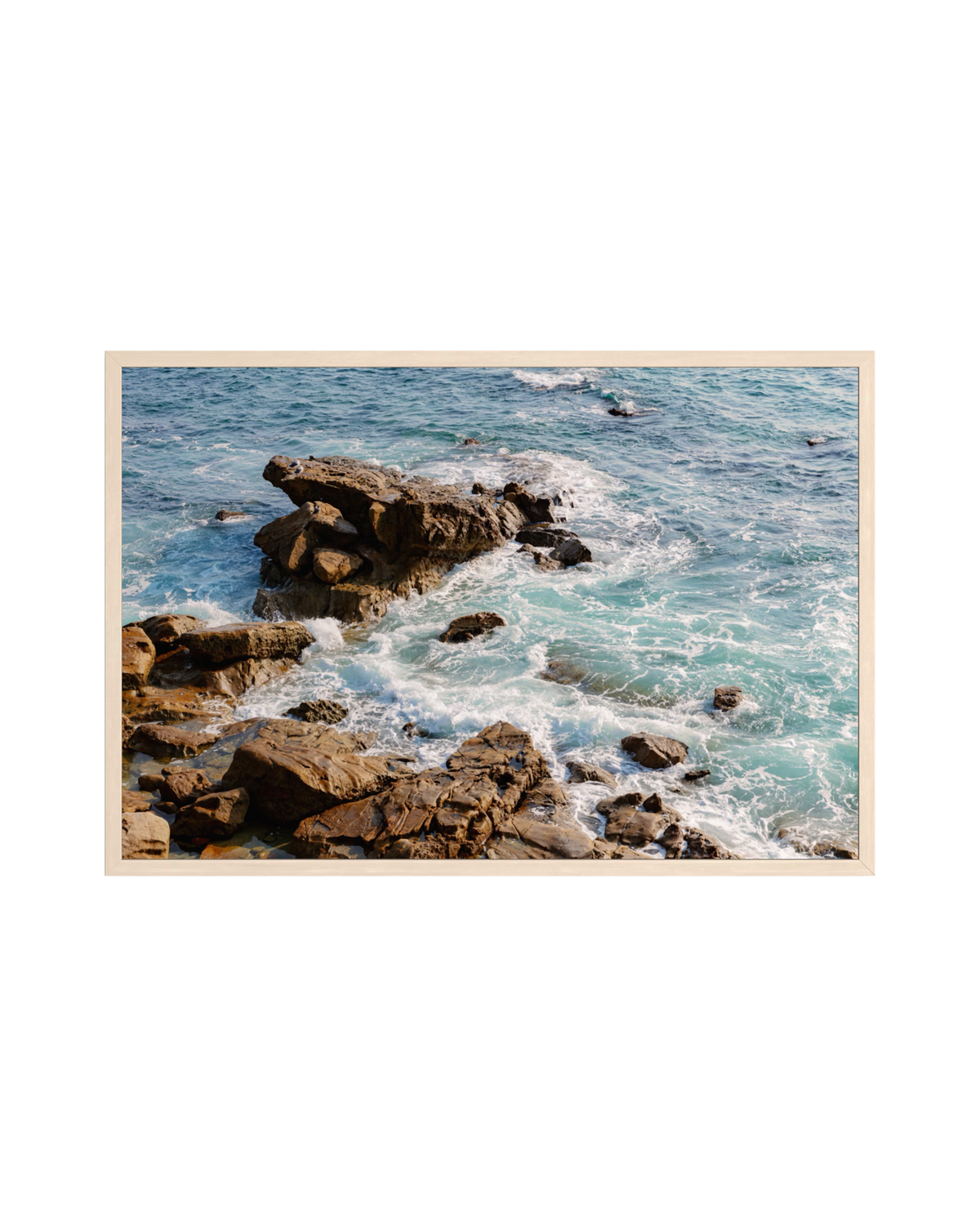 Waves breaking on turquoise water beneath a clear sky at Laguna Beach, California.