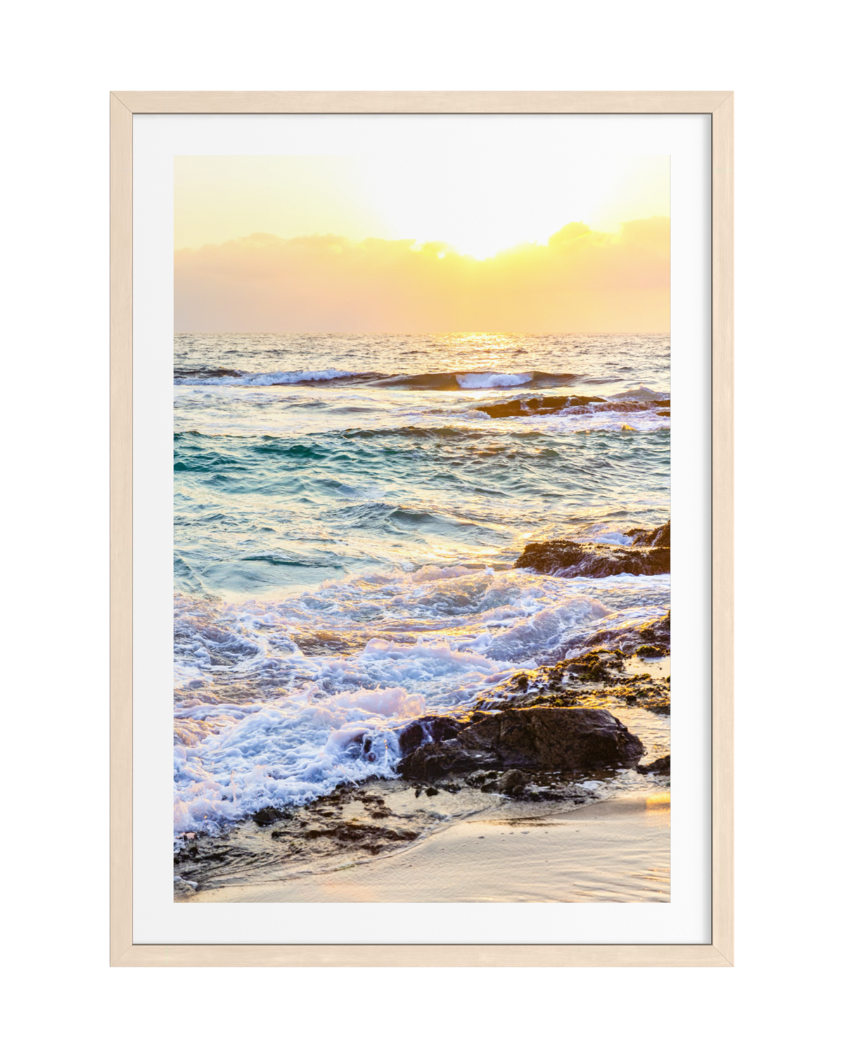 Waves and rocks at sunset, photograph matted in white and framed with light wood.
