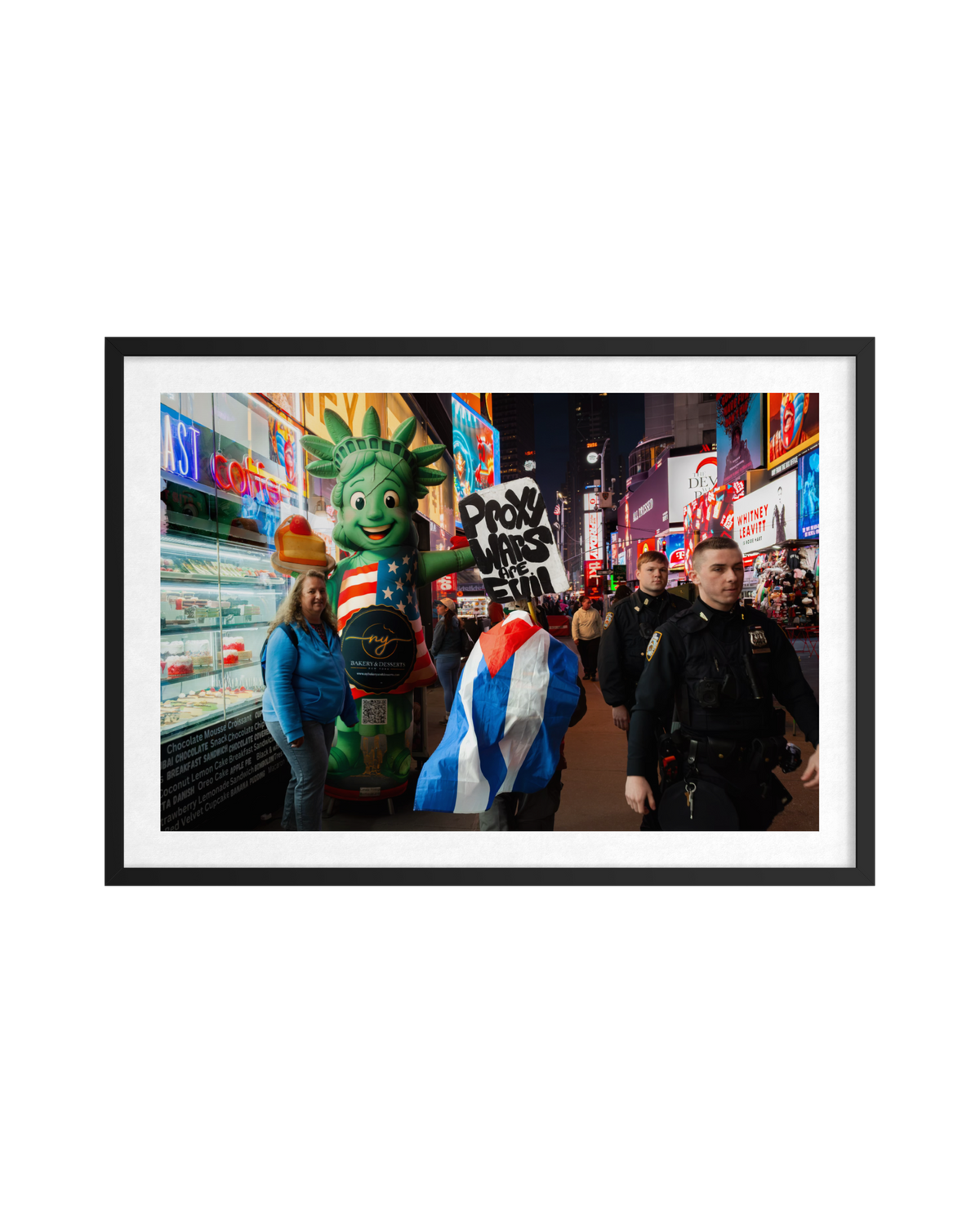 Lady Liberty mascot and a police officer in busy, brightly lit Times Square near “Proxy Wars Are Evil” signs.