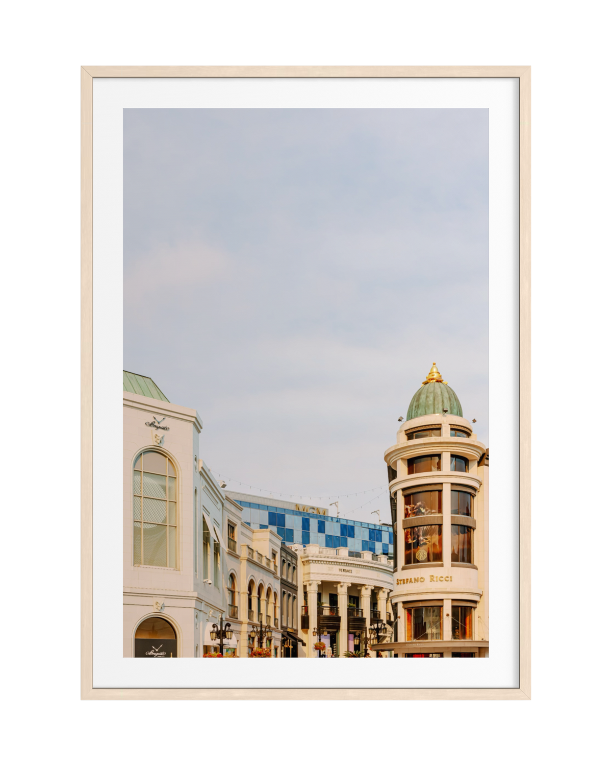 Rodeo Drive scene in Beverly Hills with domed building, storefront, and clear blue sky in a framed photograph.
