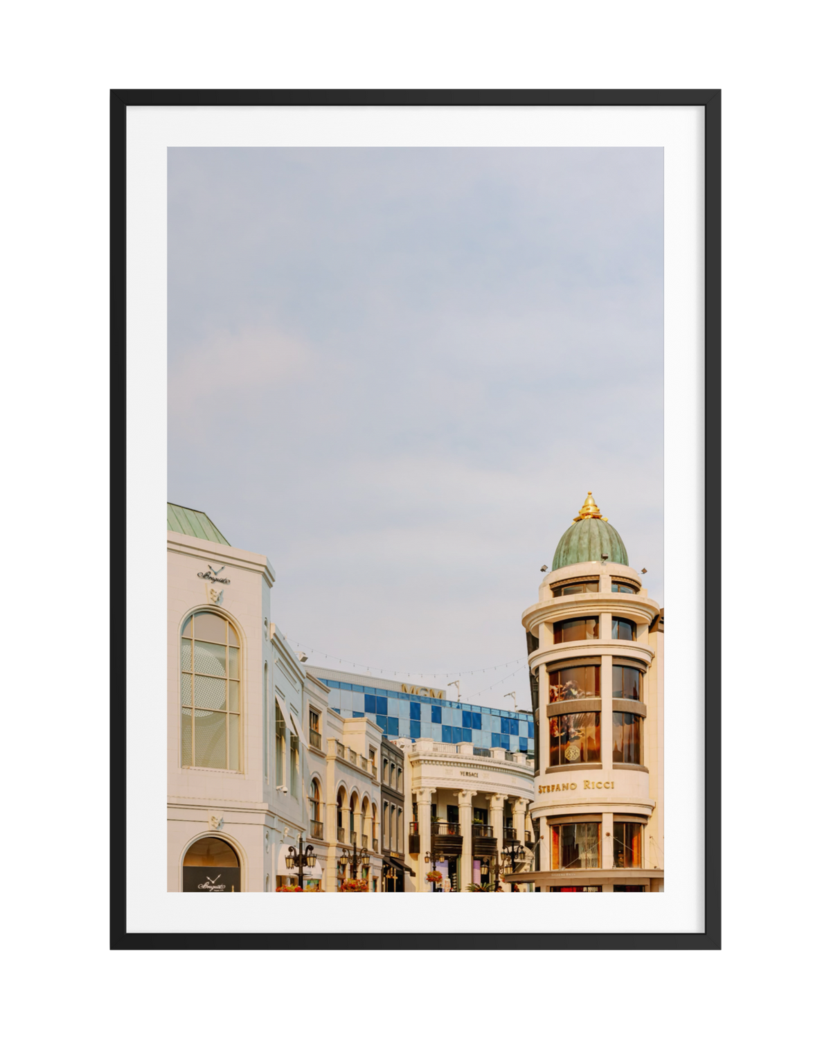 Rodeo Drive street view in Beverly Hills with domed building, Brand Ricci sign, and clear sky.