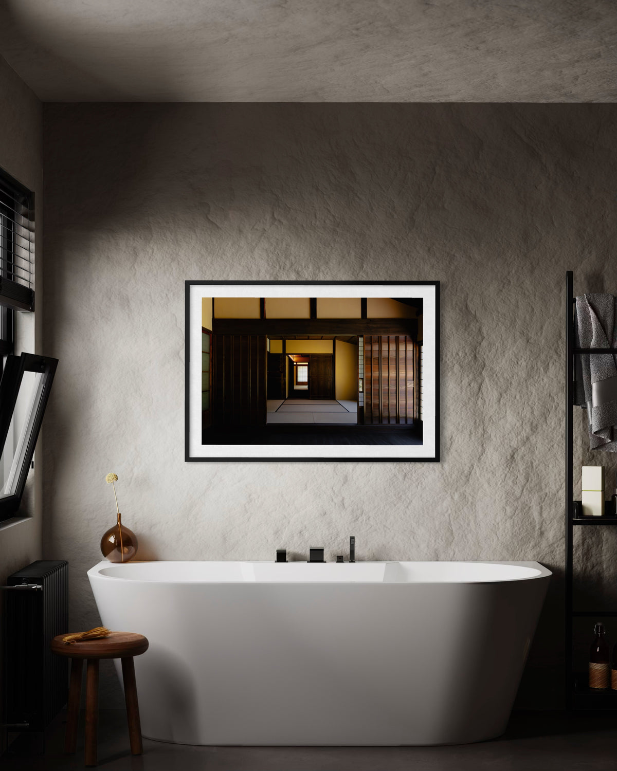 White tub with deep wood details, small stool, and geometric art on a textured wall in Shōya House Interior bathroom.