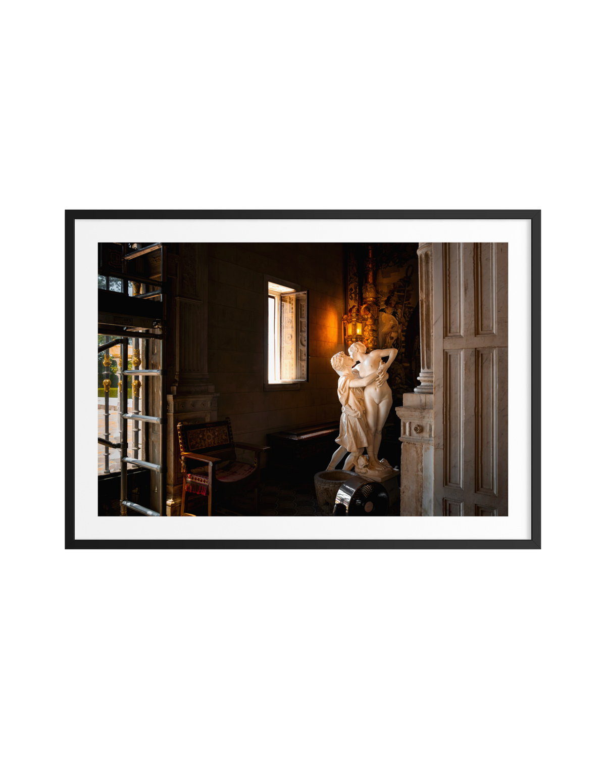 Marble “Stolen Kiss” couple sculpture lit by sunlight through a window, framed and ready to hang.