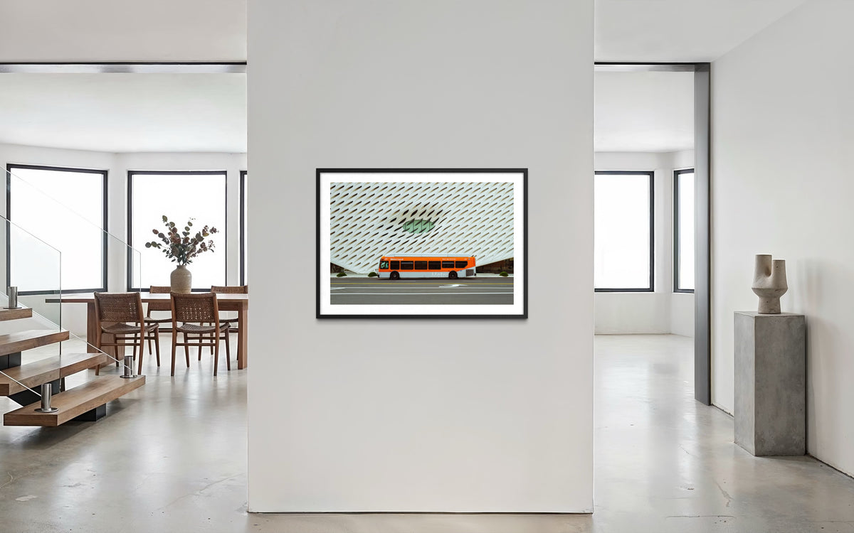 Framed print of The Broad museum, Los Angeles, displayed on a modern wall in a bright living room with large windows.