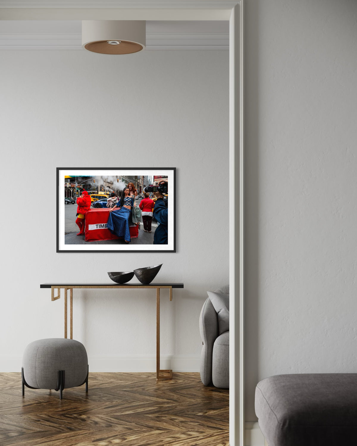Framed “Times Square Confluence” print displayed above a console table with decorative bowls in a hallway setting.