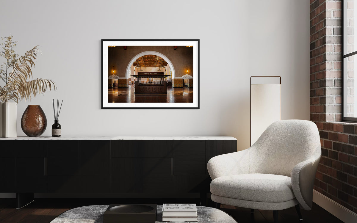 Framed “Union Station Information” art on a white wall above a sofa in a modern living room mockup.