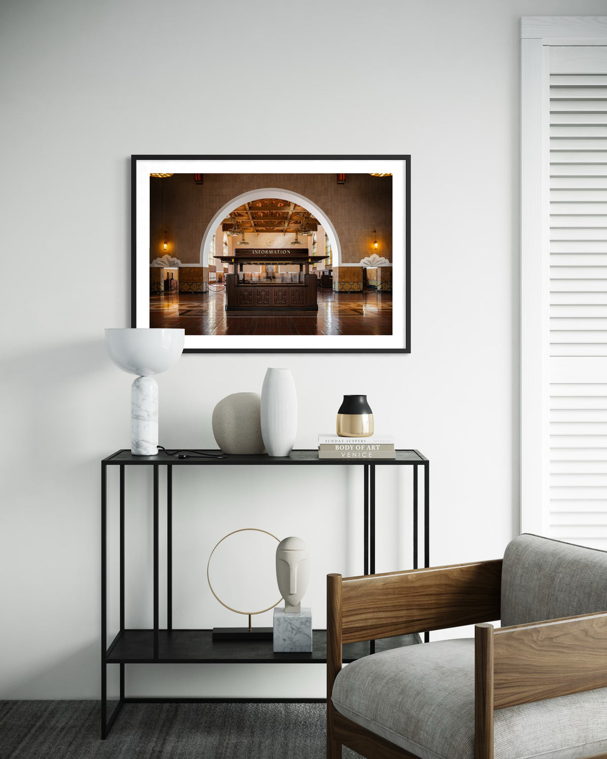 Framed Union Station Information photo from Kansas City hangs above a white wall in a minimalist living room.