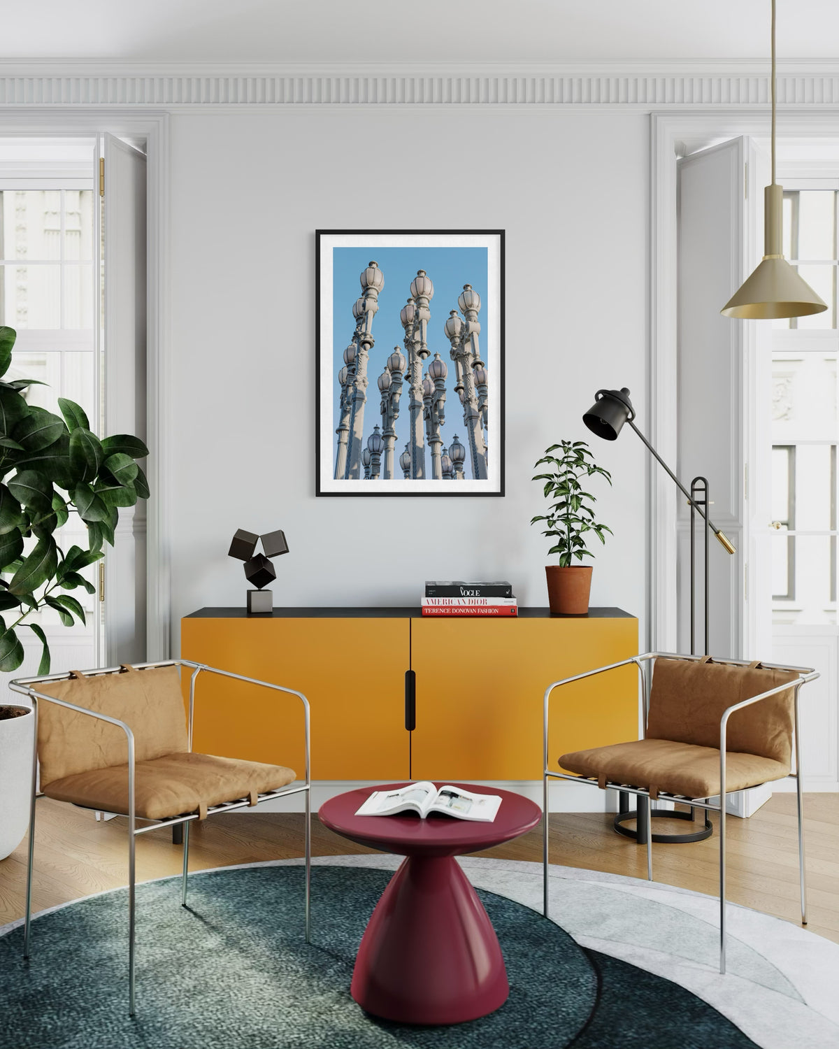Yellow cabinet, tan chairs, red table, plants, and Urban Lights artwork in a contemporary living room setting.