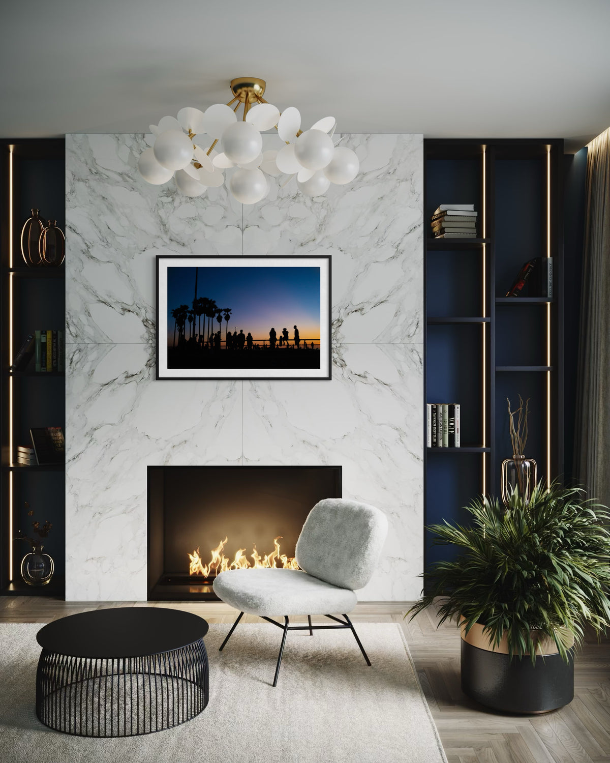 Gray chair, round table, and marble fireplace beneath “Venice Beach Summer Night” artwork in modern living room.