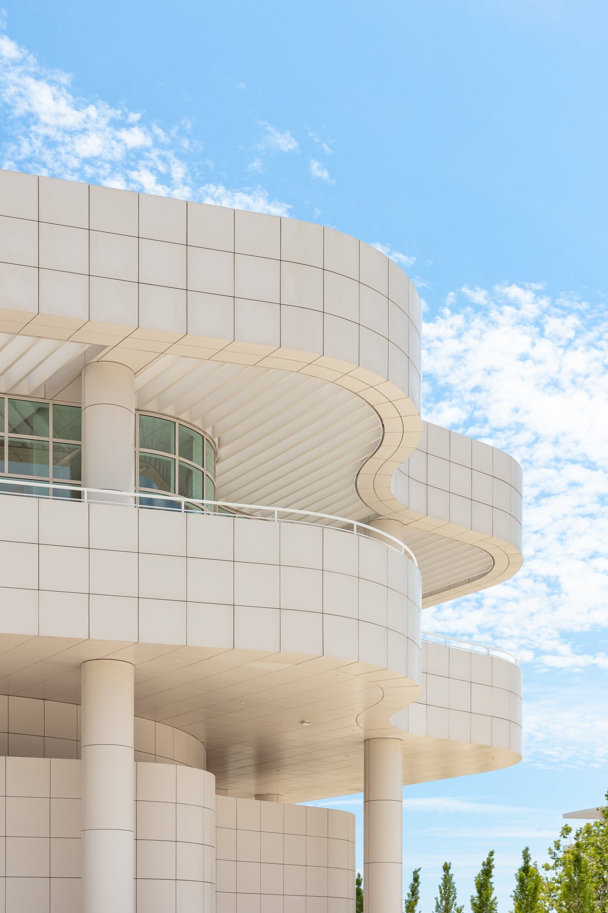 Curved white modern building at the Getty Center in Los Angeles, set against a clear sky.